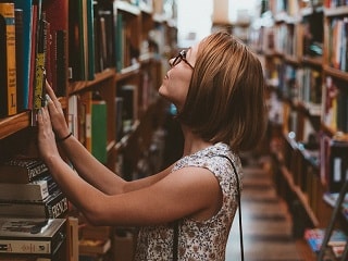 photo of woman in library
